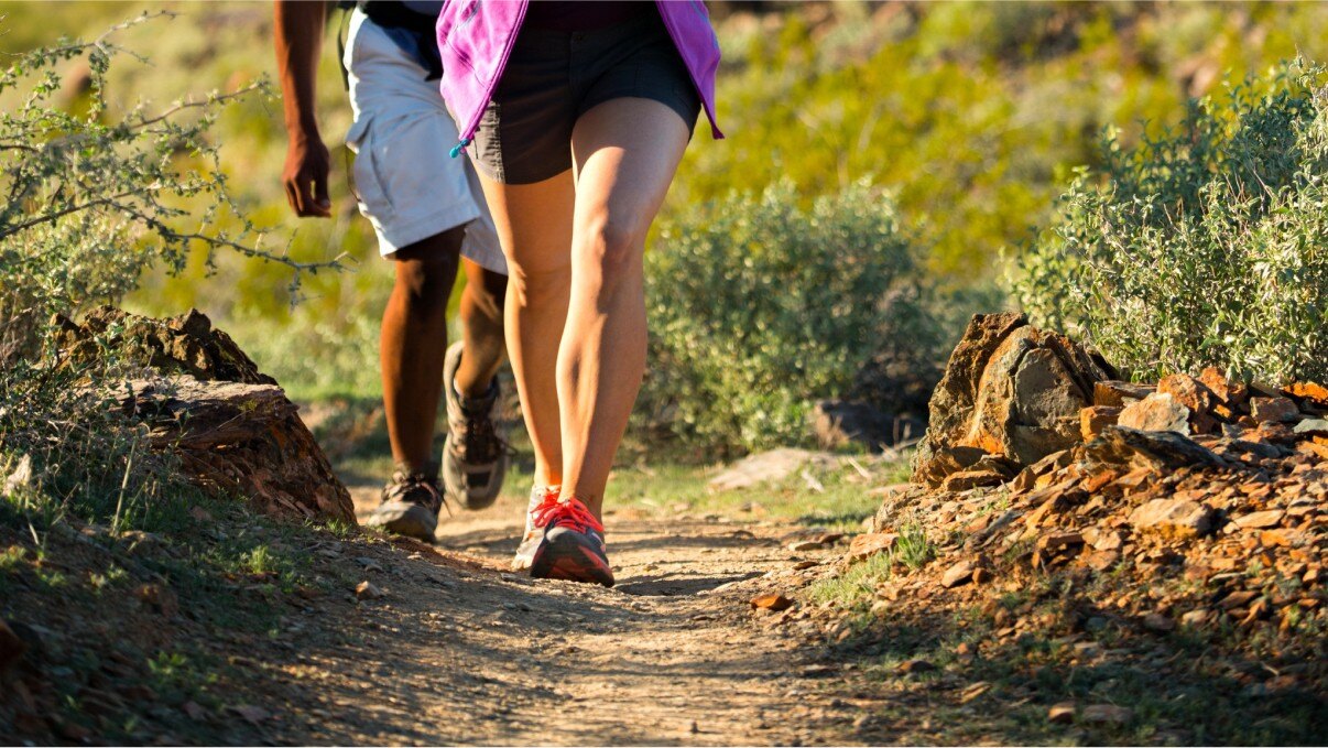 Man and woman hiking on a desert trail